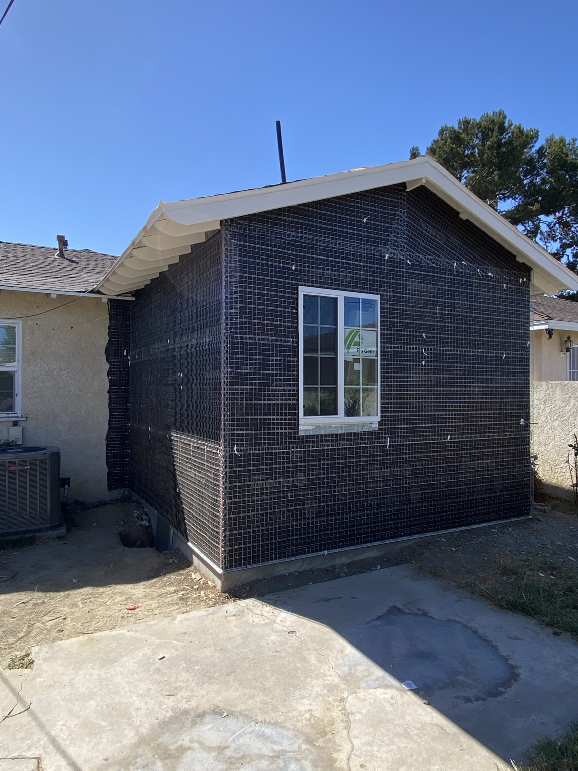 Home addition under construction with a newly installed window